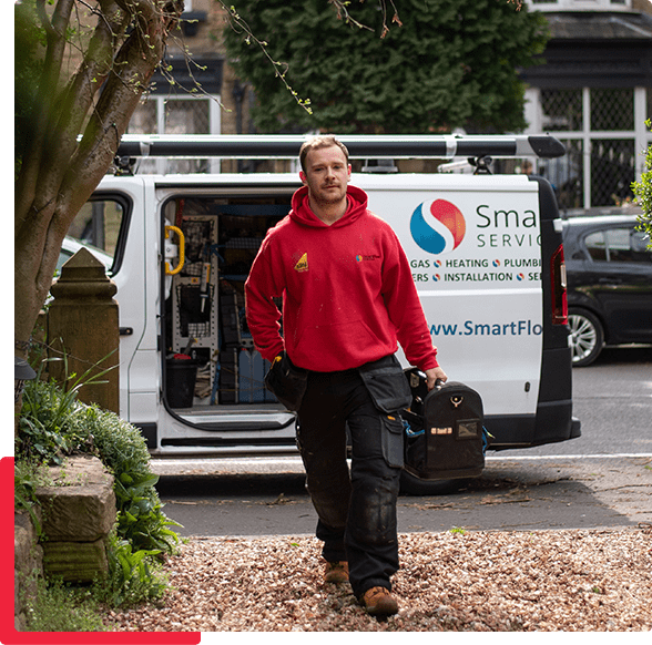A professional service technician with a toolbox stepping out of a mini van.